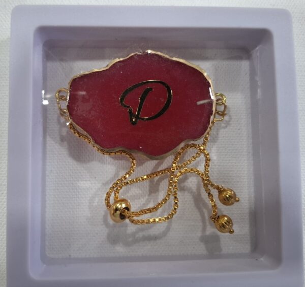 Rakhi cum Bracelet – Red “D” Initial Resin Charm