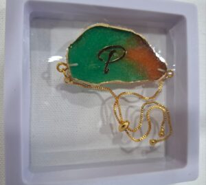 Rakhi cum Bracelet – Green-Orange “P” Initial Resin Charm