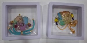 Rakhi cum Bracelet – Floral Pastel Ganesha with Blue Thread